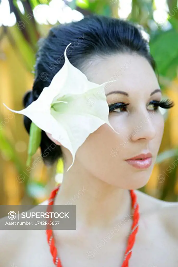 Woman wearing a large flower in her hair