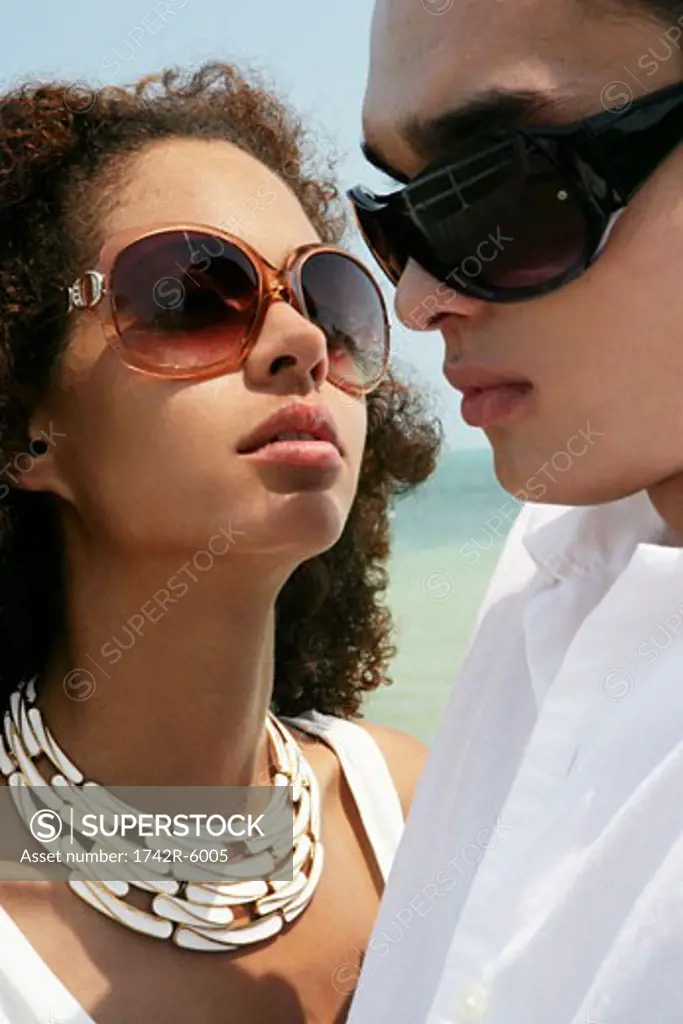 Close-up of young couple at beach.