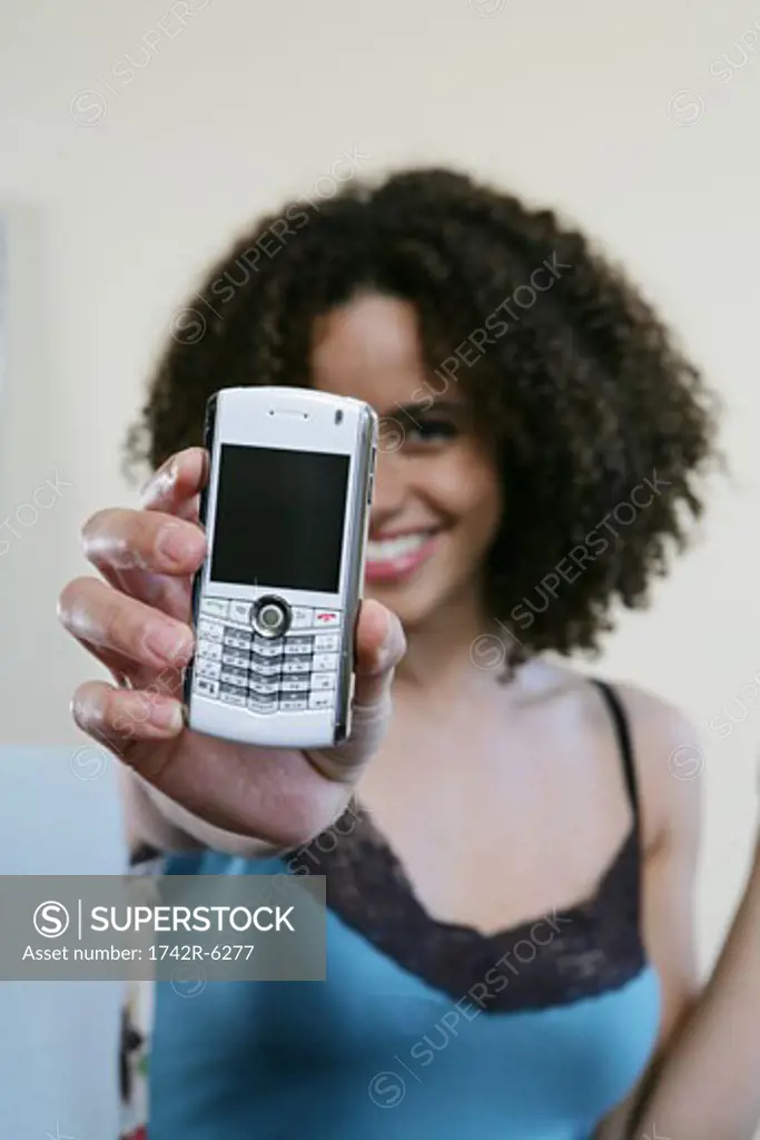 Woman holding a cellphone/blackberry up to camera