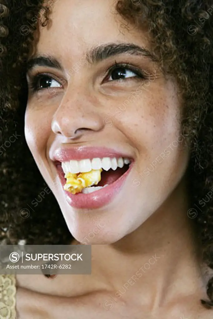 Woman smiling with popcorn between her teeth