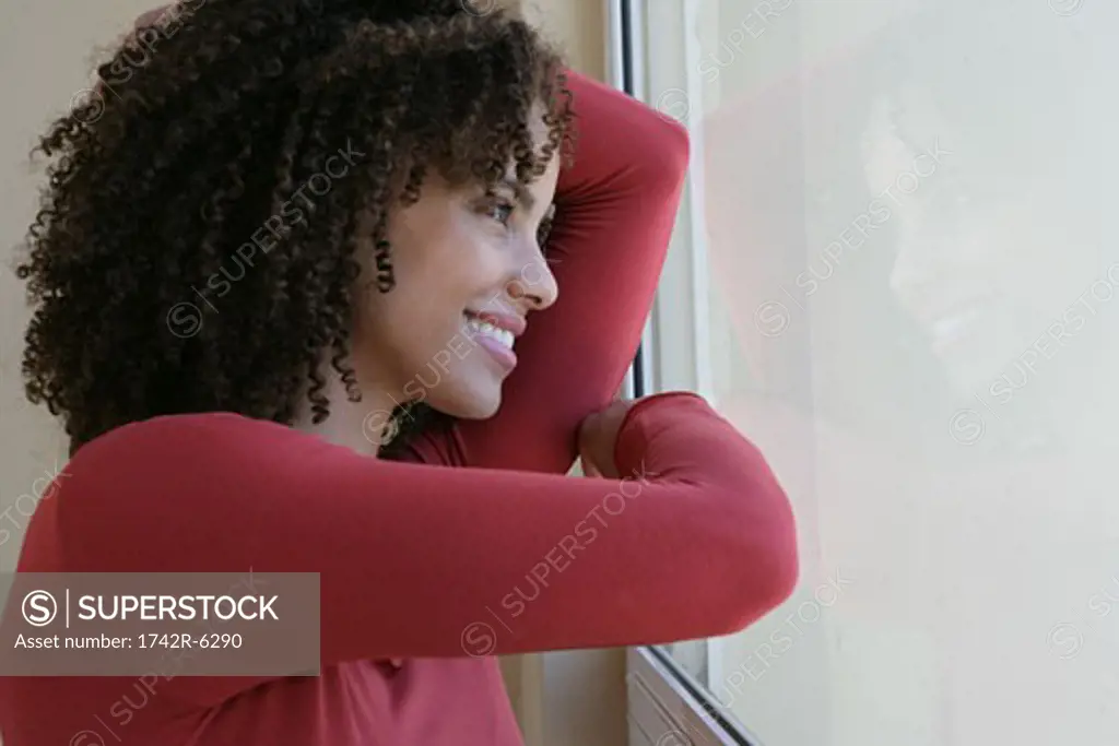 Woman leaning on a window pane
