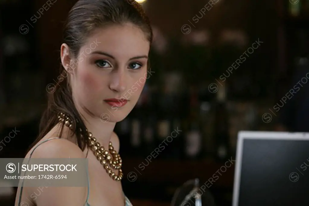 Portrait of young woman with laptop.