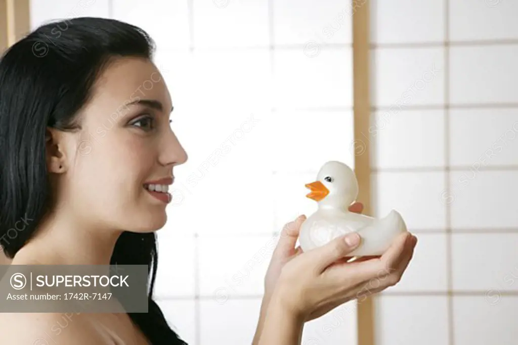 Young woman holding rubber duck.
