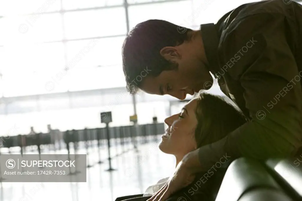 Young affectionate couple in airport.