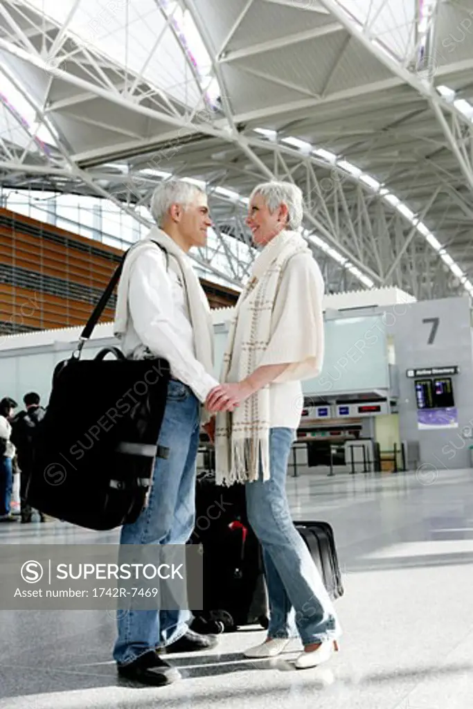 Happy mature couple at the airport.