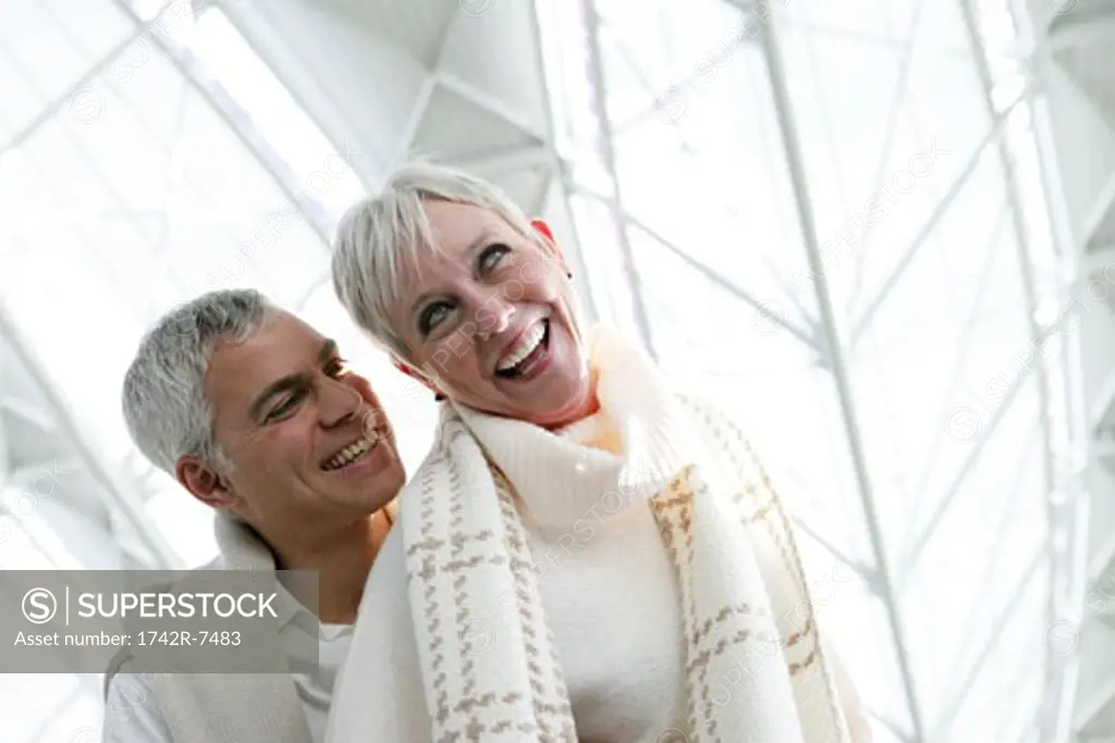 Happy mature couple in airport.