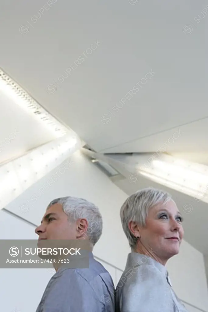 Mature couple standing in airport.