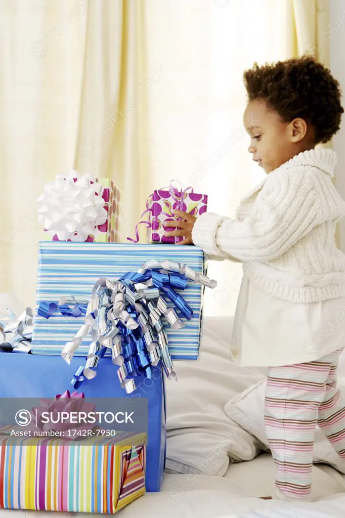 African American child with birthday presents.