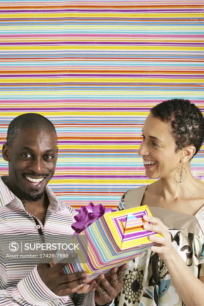 African American couple with birthday present.