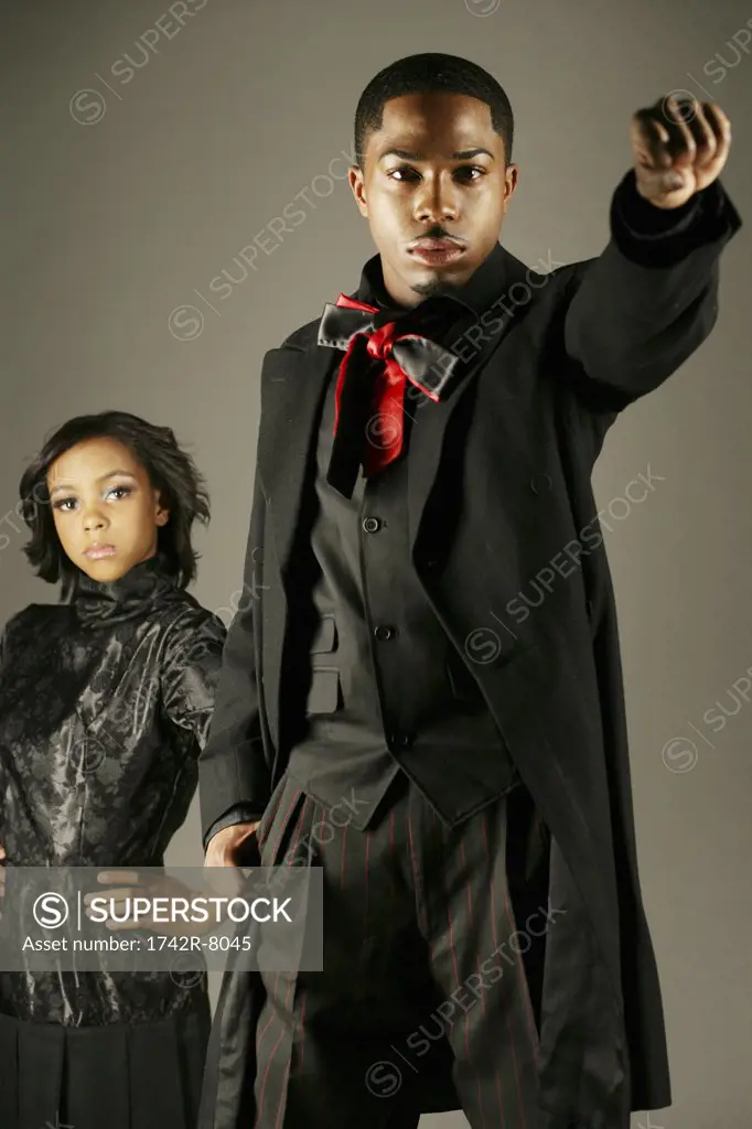 Young African American man with fist up, woman behind.