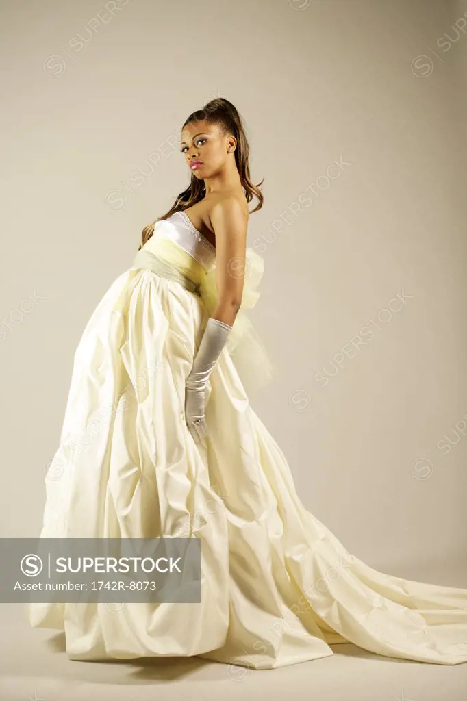Young African American woman in elegant gown, studio shot.