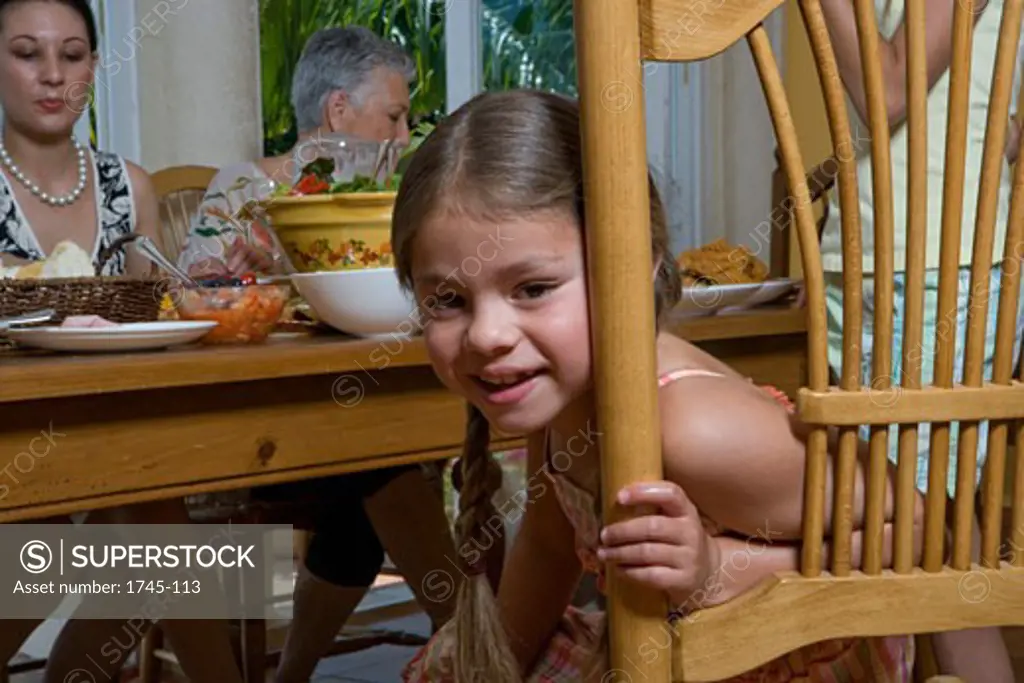 Girl sitting in a chair at a dining table