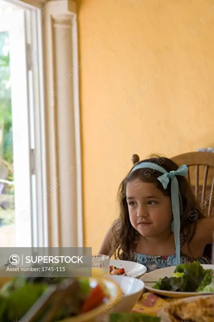 Girl sitting at a dining table