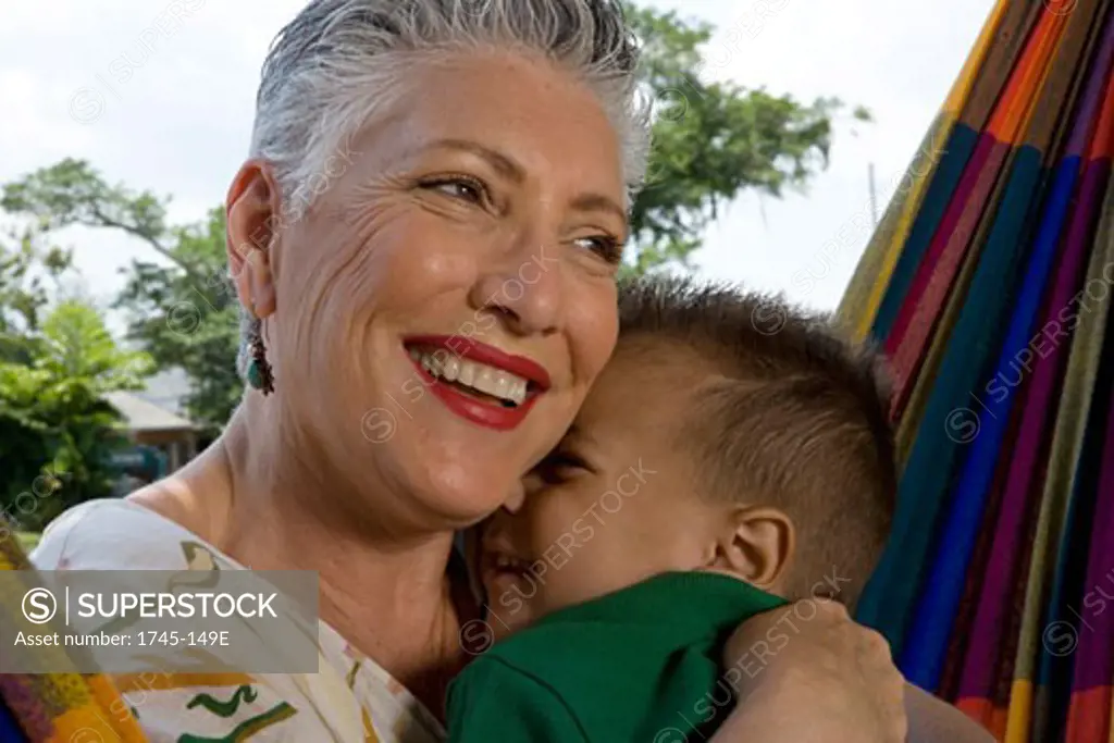 Close-up of a senior woman hugging her grandson