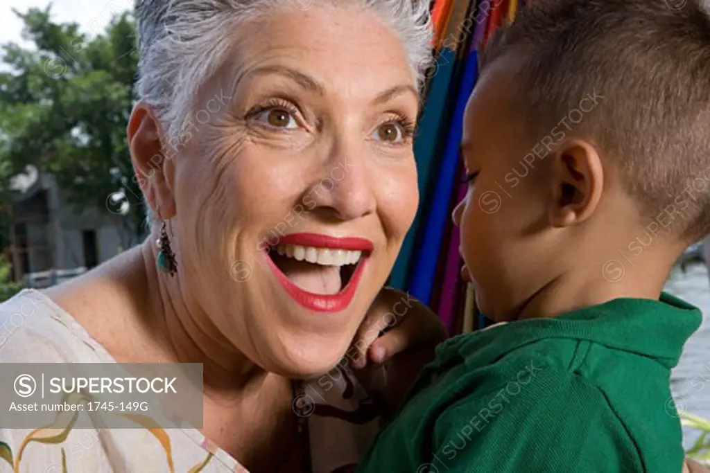 Close-up of a senior woman looking surprised with her grandson