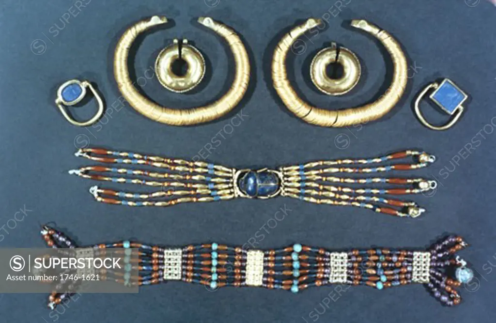 Ancient Egyptian jewellery. In the centre of the middle item is a carving of sacred scarab beetle. British Museum, London.