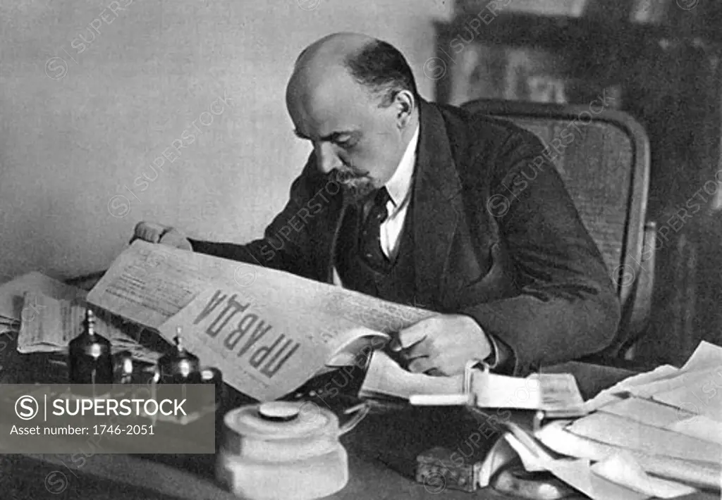 Vladimir Lenin (1870-1924) Russian revolutionary, reading "Pravda" in 1918