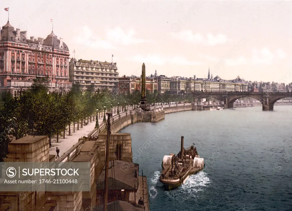 Colour photograph of a steam paddle boat along the North embankment of the River Thames in London showing Waterloo Bridge Area. Dated 1900