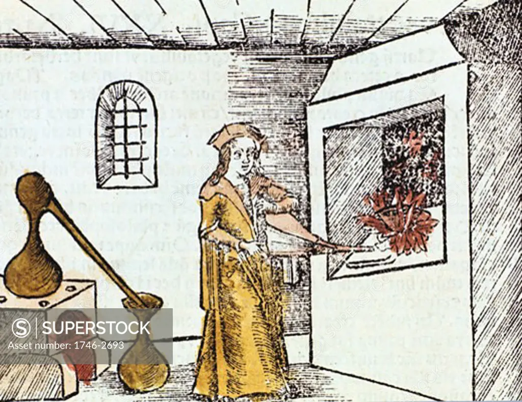 The Chemist, 1508, The Chemist or Alchemist is using bellows to heat up the fire under under a crucible. Behind him an alembic standing on a furnace is being used for distillation. Distillate condenses in rounded hood of alembic and runs down through beak into collecting vessel. From Margarita philo