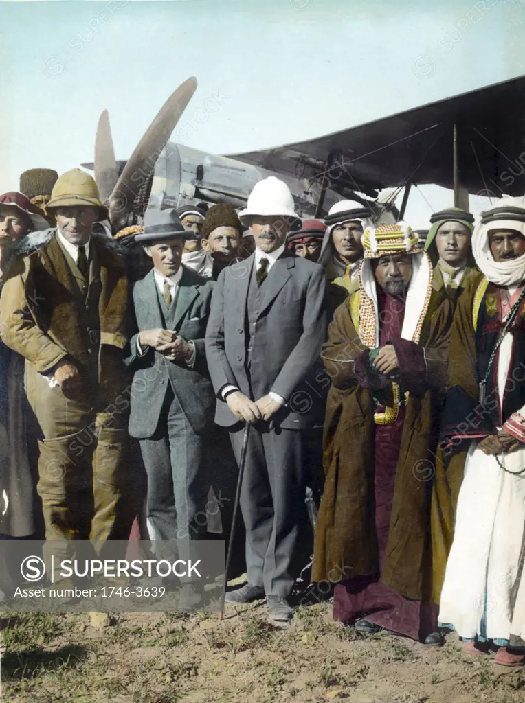 On the airfield at Amman,  Jordan, April 1921:  T E Lawrence,  Sir Herbert Samuel (British High Commissioner of Palestine), Emir Abdullah. Woman far left, possibly Gertrude Bell. Sheik Majid Pasha el Adwan, far right.
