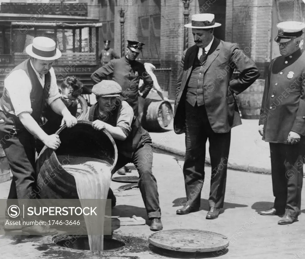 Prohibition in the USA 1920-1933: A barrel of confiscated illegal beer being poured down a drain. Alcohol Temperance  America