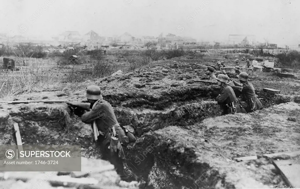 World War I 1914-1918: German soldiers entrenched on the edge of a town.