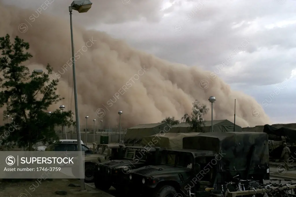 Dust storm cloud (haboob) is close to enveloping a military camp as it rolls over Al Asad Iraq 2005.
