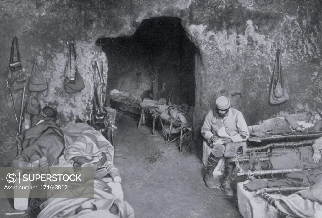 World War I 1914-1918: French soldiers resting in a grotto in a trench complex. Most are sleeping on improvised beds and one is writing a letter.   From 'Le Flambeau', Paris, September 1915.