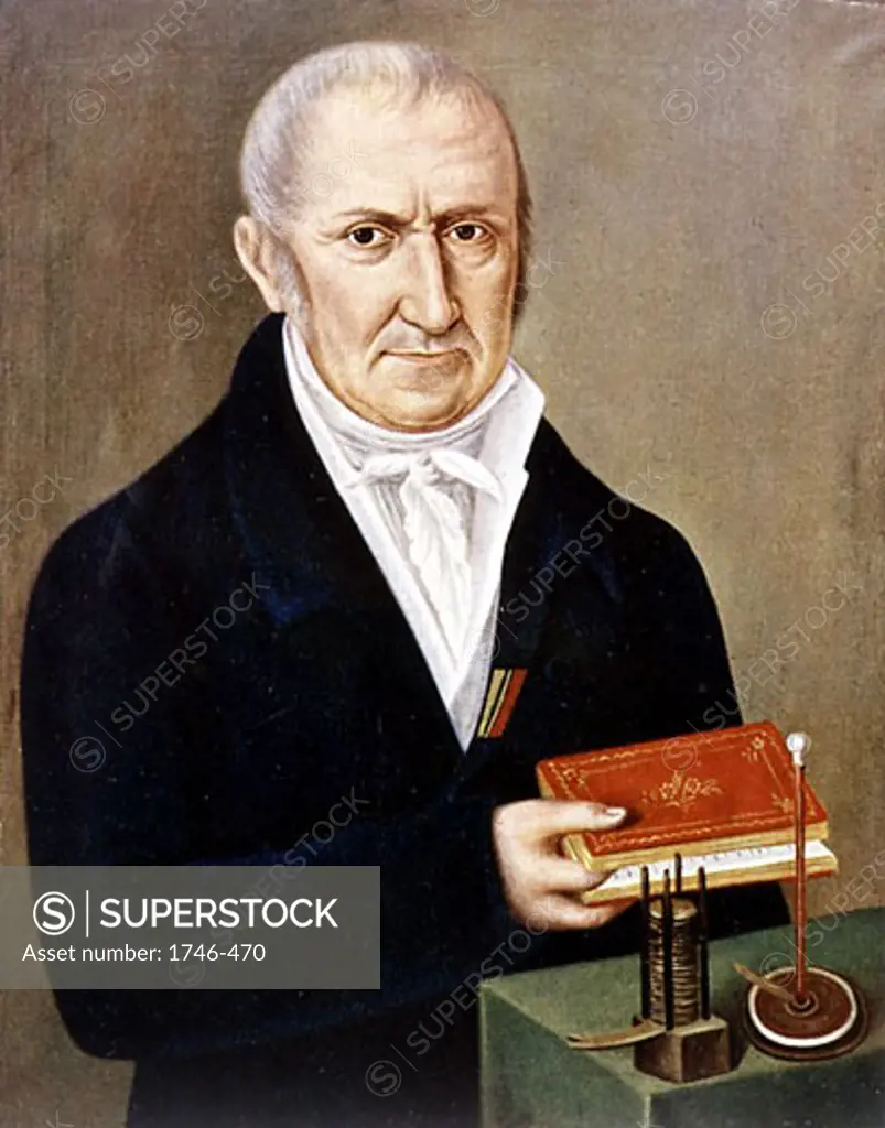 Alessandro Volta (1745-1827) Italian physicist. On table are two of his inventions, the Voltaic pile (wet battery) on left, and electrophorus, an apparatus demonstrating electrostatic charge by induction.