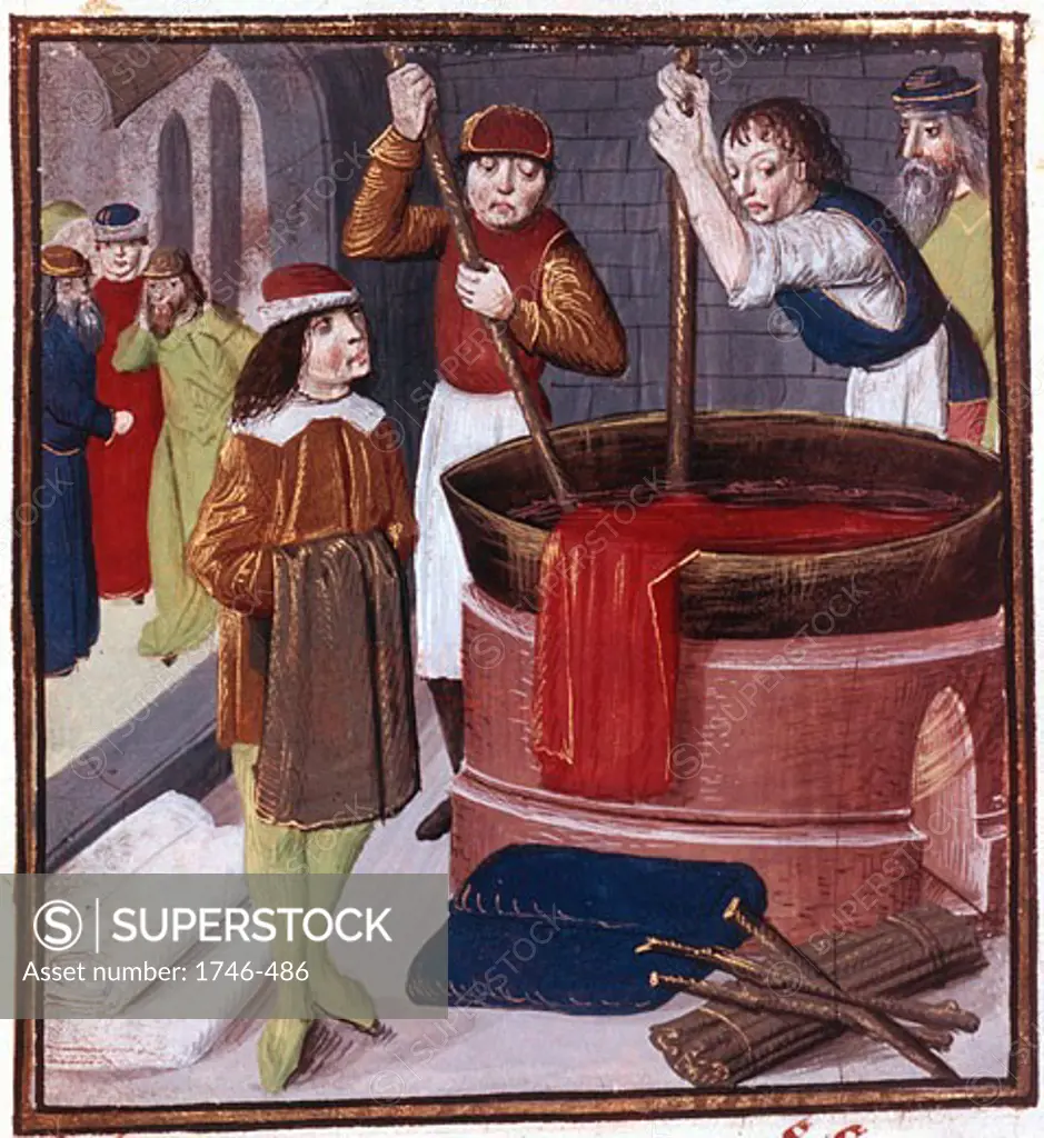 Dyers immersing bolt of cloth in vat of dye placed over a fire. At bottom right is bundle of sticks (faggot) ready to be added to fire.15th century manuscript. British Museum