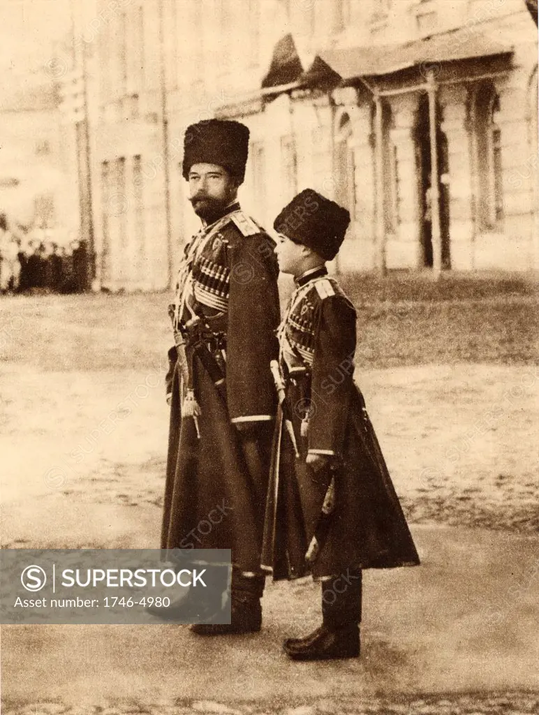 Nicholas II (1868-1918) Tsar of Russia from 1894, and his son the Tsarevich Alexei (1904-1918), reviewing Russian troops, 1915.