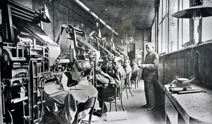 Linotype is being set to print a newspaper in Paris (typesetters and compositors are at their machines. Circa 1900-1910