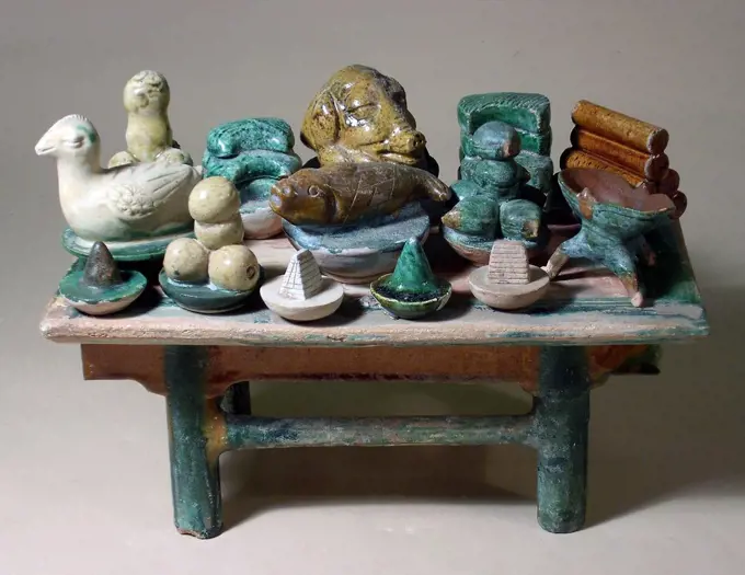 Ancient China: Offering table wth ceramic food objects. Glazed green and orange ware. Ming dynasty, 1368 - 1644 AD.