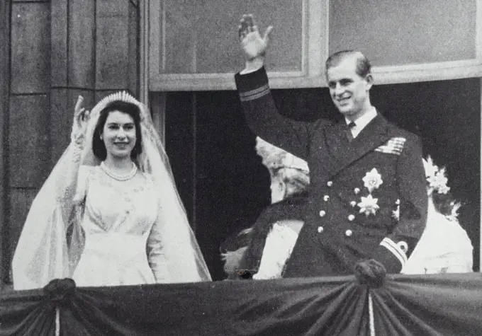 Photograph of Queen Elizabeth II and the Duke of Edinburgh waving from the balcony on their wedding day.