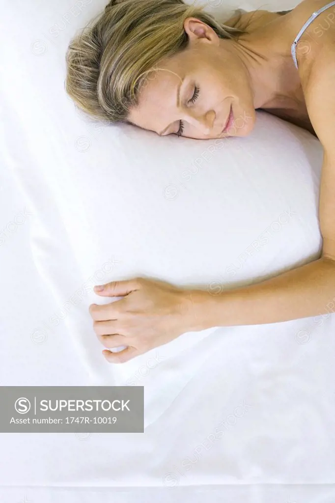 Woman sleeping on comfortable pillow, high angle view
