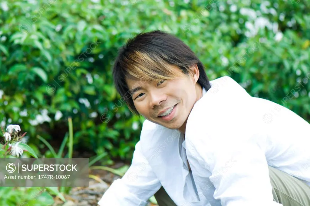 Man in garden, smiling at camera