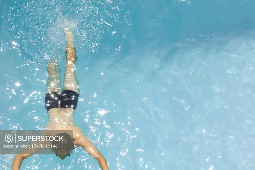Man swimming in pool, high angle view