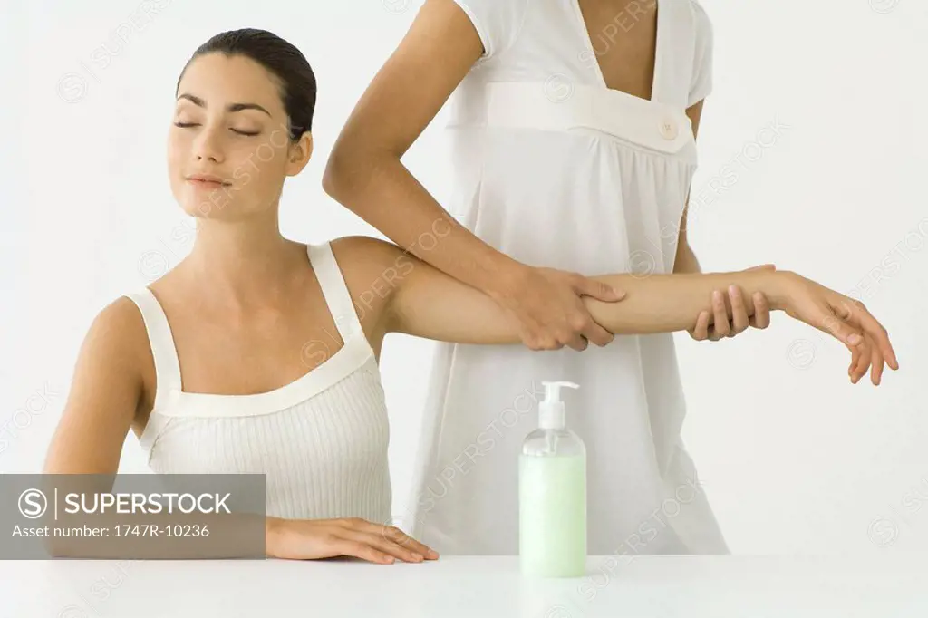 Woman receiving arm massage, eyes closed