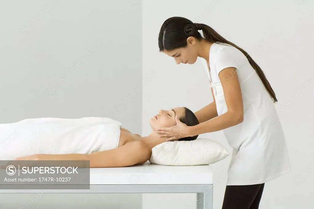 Woman receiving a head massage, side view