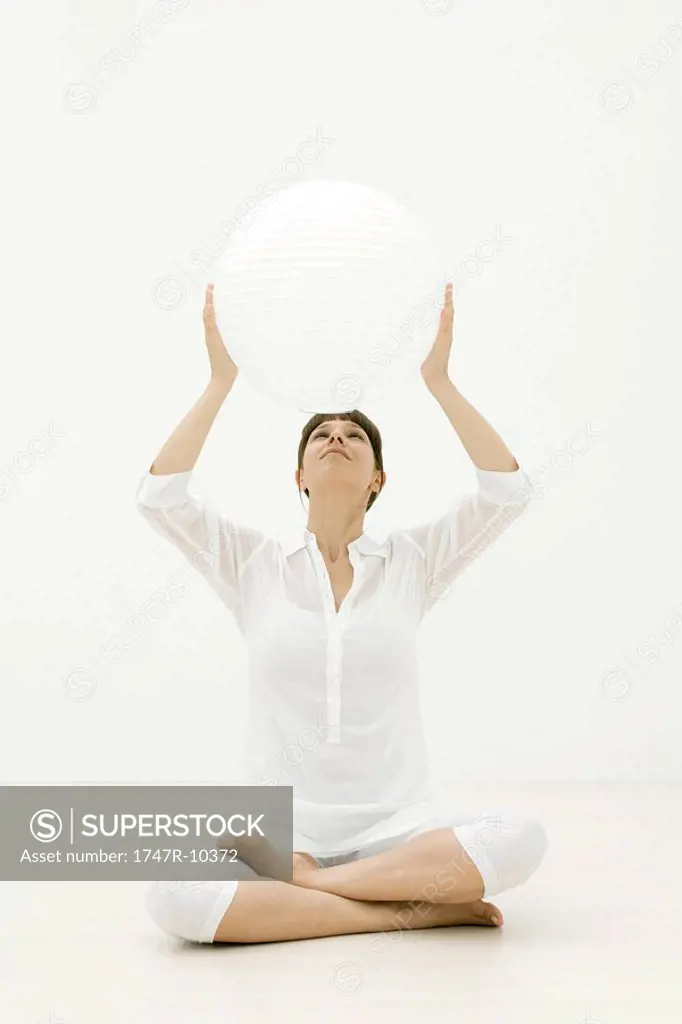Woman holding up sphere