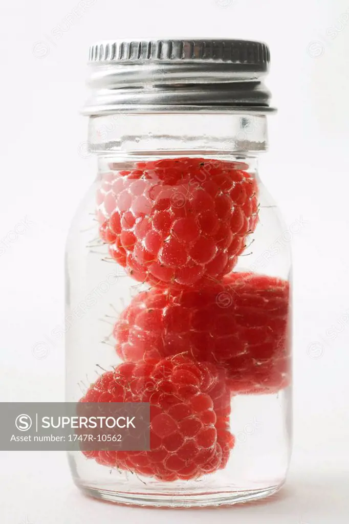 Raspberries in small jar, close-up