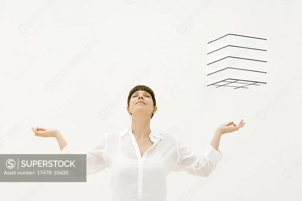 Woman meditating, cube hovering in midair over her left hand, head back, eyes closed