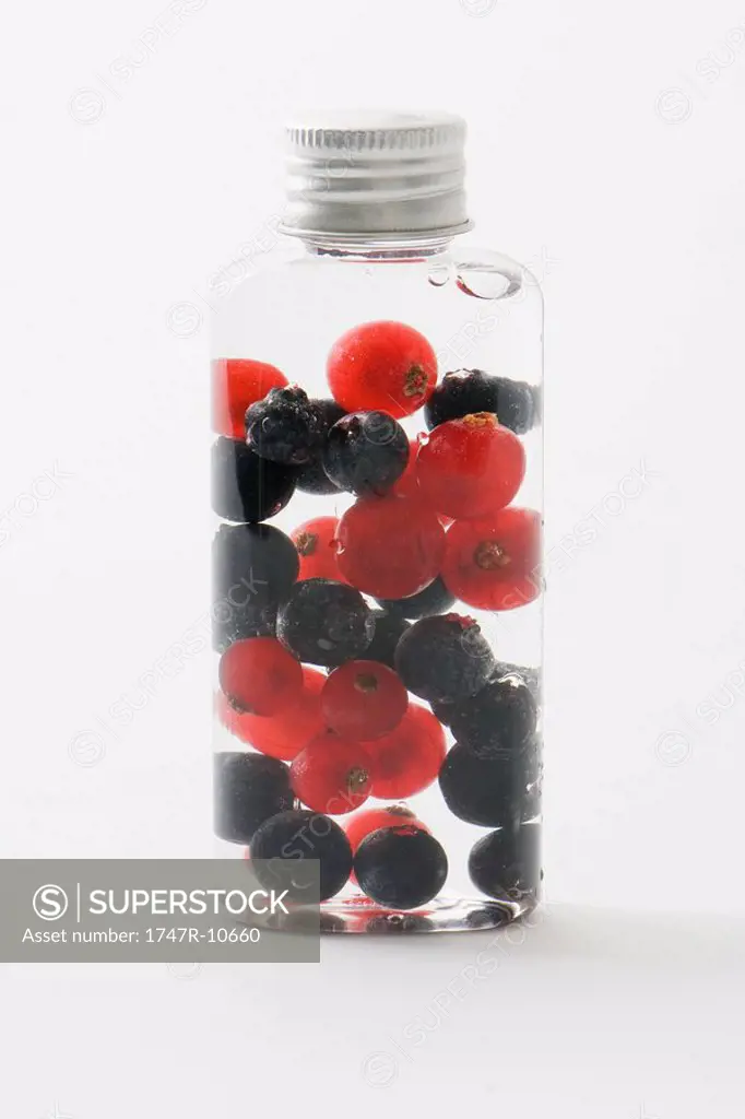 Fresh berries in cosmetic bottle