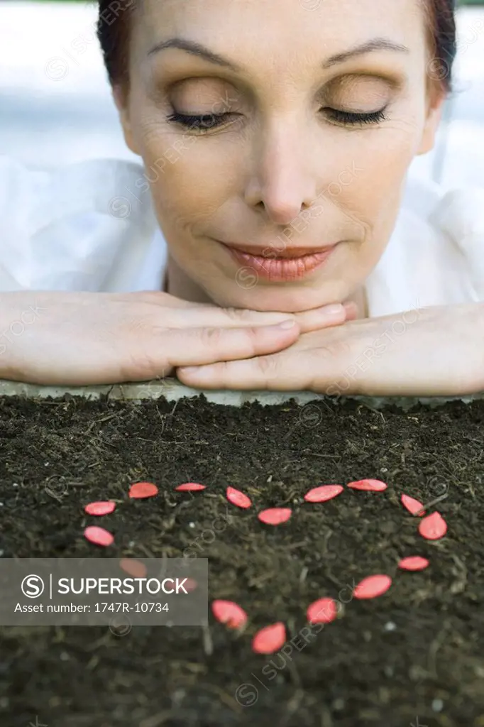 Mature woman with seeds in shape of heart