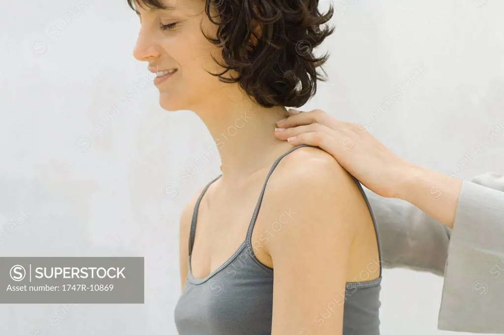 Woman receiving lower neck massage