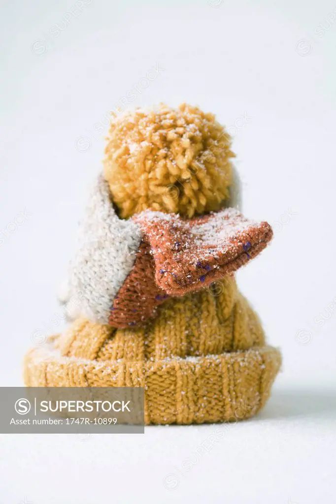 Scarf wrapped around knit hat, snow-covered