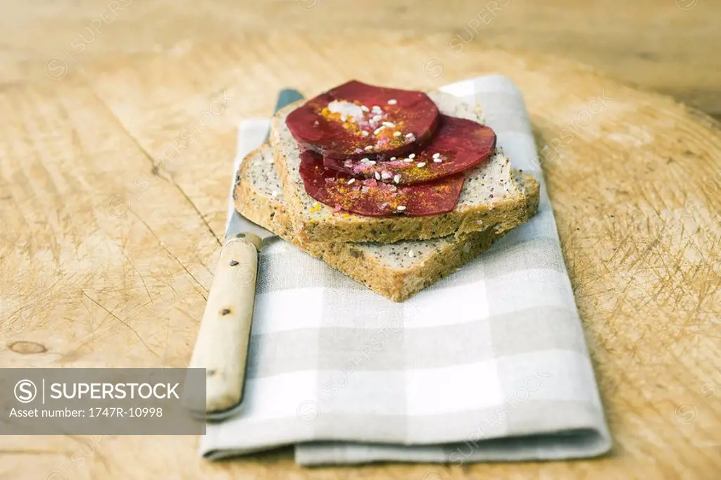 Beet slices on top of slices of bread