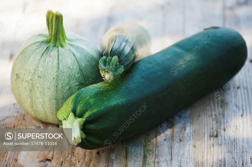 Zucchini and squash arranged on wooden background