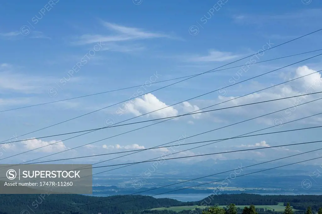Cables criss-crossing in front of scenic landscape