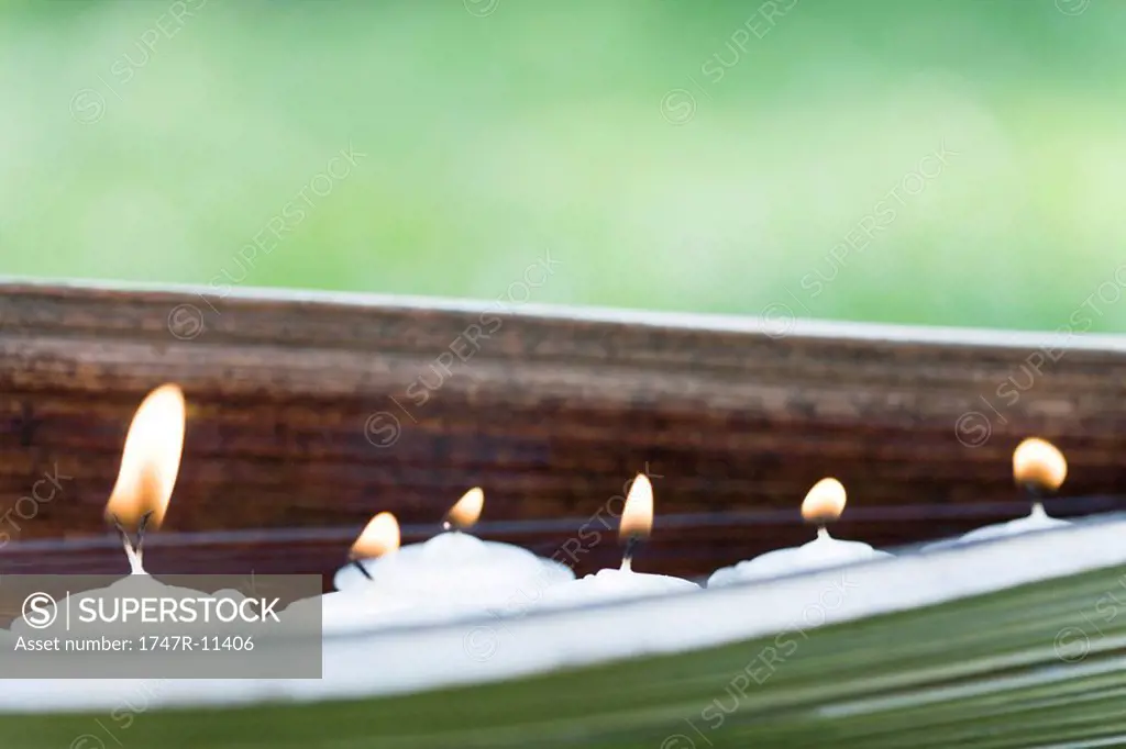 Lit votive candles in natural setting